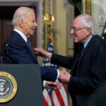 President Joe Biden stands with Sen. Bernie Sanders, I-Vt.