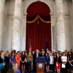 Sen. Jerry Moran, R-Kansas, center left, and Sen. Richard Blumenthal, D-Conn., attend a news conference with dozens of women and girls who were sexually abused by Larry Nassar.