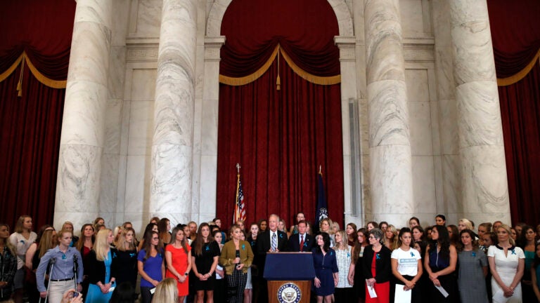 Sen. Jerry Moran, R-Kansas, center left, and Sen. Richard Blumenthal, D-Conn., attend a news conference with dozens of women and girls who were sexually abused by Larry Nassar.