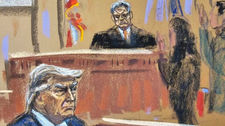 Former President Donald Trump sits as final jurors are sworn in during his criminal trial.