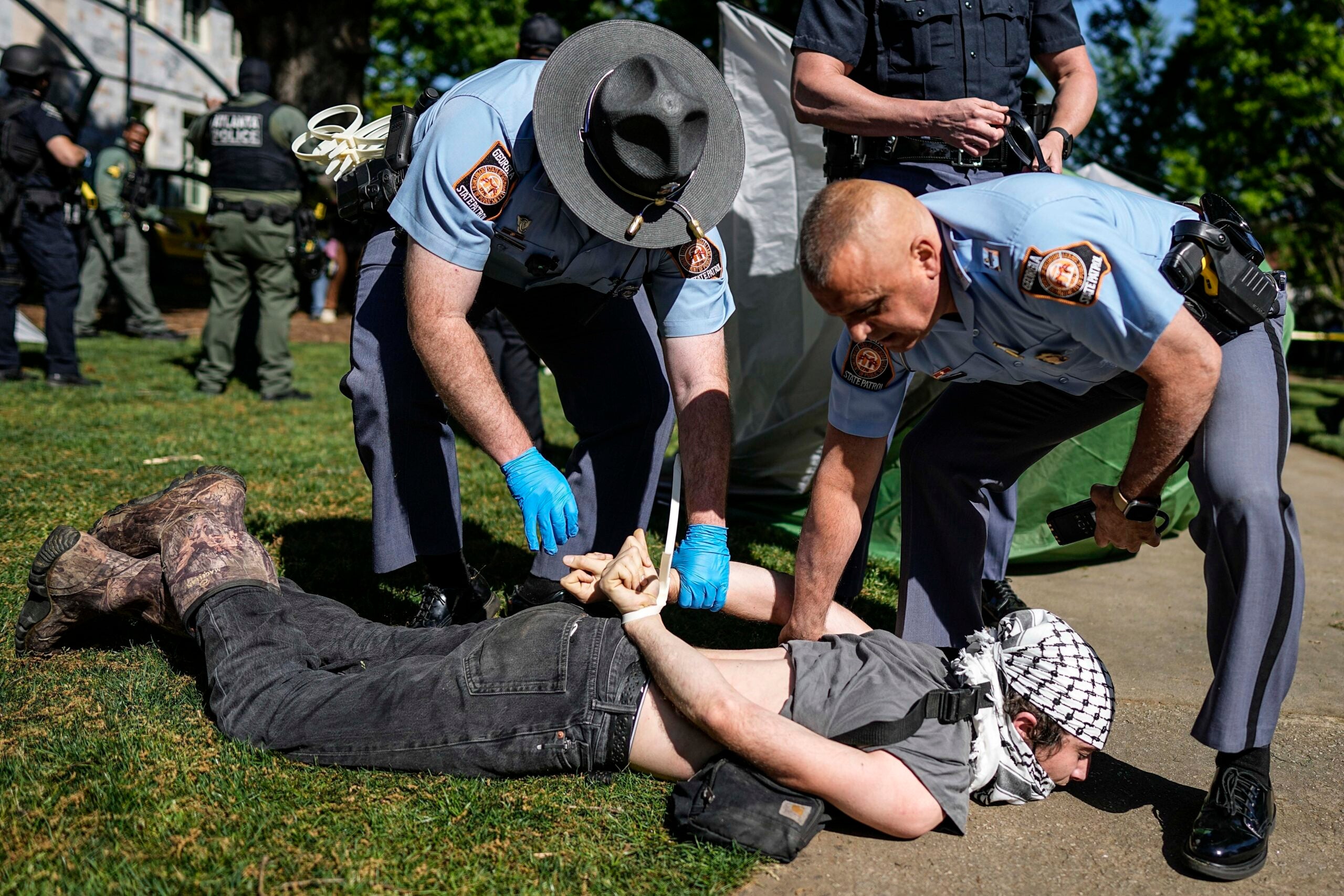 Georgia State Patrol officers detain a protester on the campus of Emory University. 