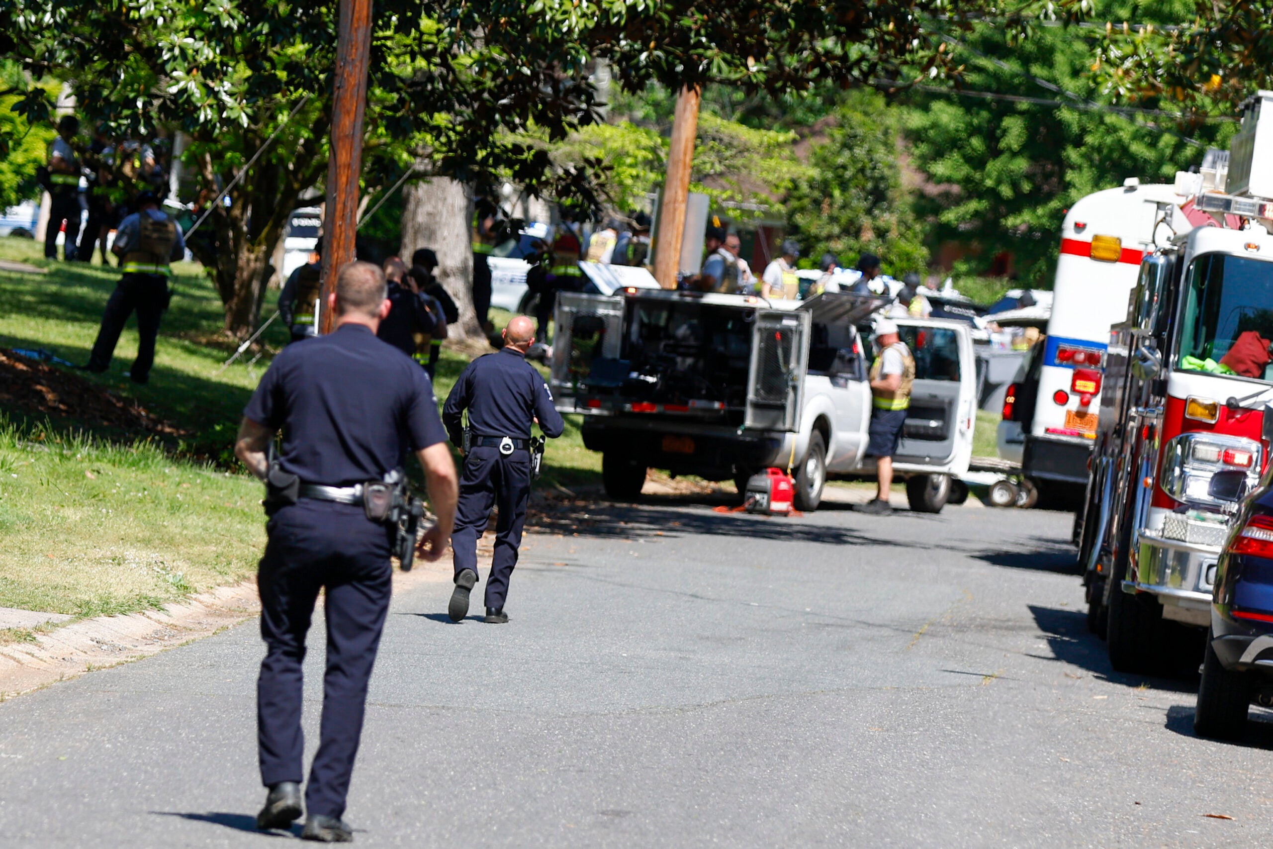 Charlotte Mecklenburg Police Department officers walk in the neighborhood where a shooting took place in Charlotte, N.C.