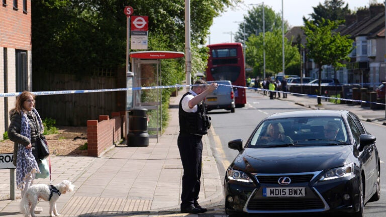 Police talking to members of the public at the scene in Hainault, north east London.