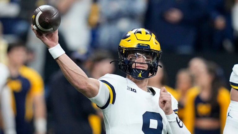 Michigan quarterback J.J. McCarthy (9) warms up before the Big Ten championship NCAA college football game against Iowa, Saturday, Dec. 2, 2023, in Indianapolis.
