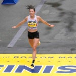 FILE - Emma Bates, of Minnesota, crosses the finish line of the Boston Marathon, April 17, 2023, in Boston.