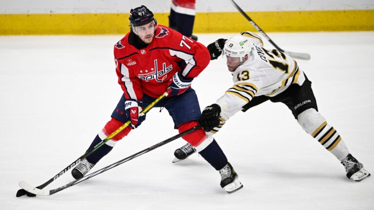 Washington Capitals right wing T.J. Oshie skates with the puck against Bruins center Charlie Coyle during the third period.