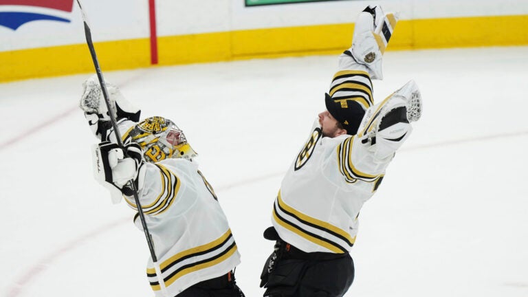 Boston Bruins goaltender Jeremy Swayman, left, and goaltender Linus Ullmark, right, celebrate after defeating the Toronto Maple Leafs in Game 4 of an NHL hockey Stanley Cup first-round playoff series in Toronto, Saturday, April 27, 2024.