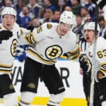 Boston Bruins' Brad Marchand (63) celebrates his goal against the Toronto Maple Leafs with Brandon Carlo and Charlie McAvoy during third period of action in Game 3 of an NHL hockey Stanley Cup first-round playoff series in Toronto on Wednesday, April 24, 2024.