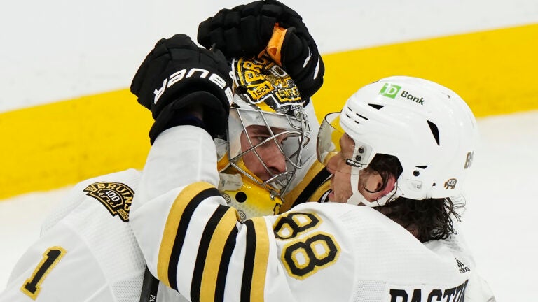 Boston Bruins goaltender Jeremy Swayman (1) and David Pastrnak (88) celebrate after defeating the Toronto Maple Leafs in Game 3 of an NHL hockey Stanley Cup first-round playoff series in Toronto on Wednesday, April 24, 2024.