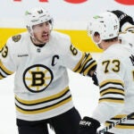 Boston Bruins' Brad Marchand (63) celebrates after his goal against the Toronto Maple Leafs with Charlie McAvoy (73) during second-period action in Game 4 of an NHL hockey Stanley Cup first-round playoff series in Toronto, Saturday, April 27, 2024.
