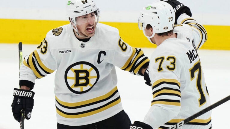 Boston Bruins' Brad Marchand (63) celebrates after his goal against the Toronto Maple Leafs with Charlie McAvoy (73) during second-period action in Game 4 of an NHL hockey Stanley Cup first-round playoff series in Toronto, Saturday, April 27, 2024.