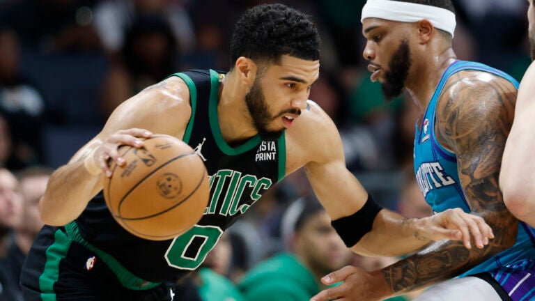 Celtics forward Jayson Tatum drives against Charlotte Hornets forward Miles Bridges during the first half.