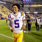 LSU quarterback Jayden Daniels (5) runs off the field following a win over Florida in an NCAA college football game in Baton Rouge, La., Saturday, Nov. 11, 2023.