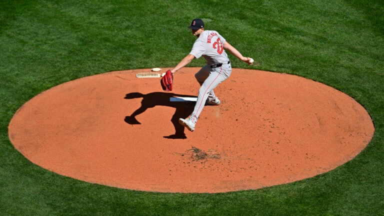 Aerial photo of a baseball pitcher throwing off a mound.