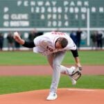 Former New England Patriots NFL football player Rob Gronkowski spikes the ball instead of throwing it during the ceremonial first pitch before a baseball game between the Boston Red Sox and the Cleveland Guardians, Monday, April 15, 2024, in Boston.