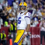 LSU quarterback Jayden Daniels (5) celebrates after running for a touchdown against Alabama during the first half of an NCAA college football game, Saturday, Nov. 4, 2023, in Tuscaloosa, Ala.