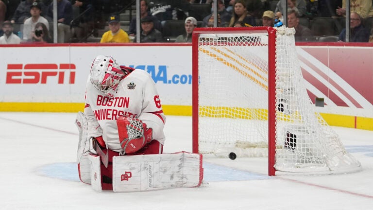 Boston University goaltender Mathieu Caron was unable to stop Tristan Broz's shot in overtime that delivered a 2-1 victory for Denver in the NCAA men's hockey national semifinals.