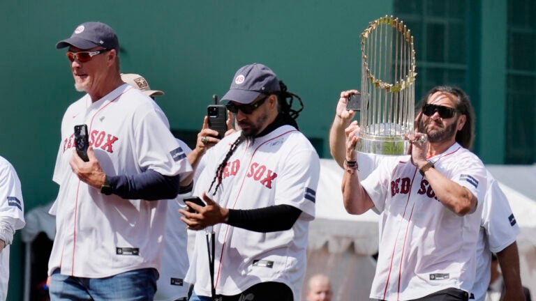 Members of the 2004 Boston Red Sox World Series championship team, Johnny Damon, right, Manny Ramirez, center, and Mike Timlin take the field during ceremonies before an opening day baseball game at Fenway Park against the Baltimore Orioles, Tuesday, April 9, 2024, in Boston.