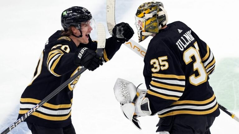 Boston Bruins' Jesper Boqvist (70) celebrates with Linus Ullmark (35) after scoring in overtime of an NHL hockey game against the Florida Panthers, Saturday, April 6, 2024, in Boston.