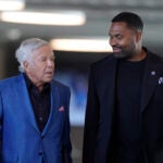 New England Patriots owner Robert Kraft, left, and newly-named Patriots head coach Jerod Mayo, right, walk together Wednesday, Jan. 17, 2024, as they arrive at an NFL football news conference, in Foxborough, Mass. Mayo succeeds Bill Belichick as the franchise's 15th head coach.