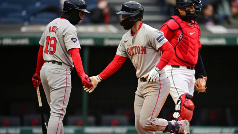 Red Sox's Connor Wong, front right, is congratulated by Pablo Reyes for a solo home run off Cleveland Guardians starting pitcher Carlos Carrasco during the sixth inning.