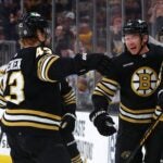 BOSTON, MASSACHUSETTS - FEBRUARY 29: Morgan Geekie #39 of the Boston Bruins celebrates with David Pastrnak #88 and Danton Heinen #43 after scoring his second goal of the game against the Vegas Golden Knights during the first period at TD Garden on February 29, 2024 in Boston, Massachusetts.