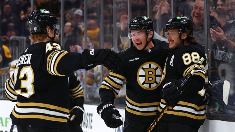 BOSTON, MASSACHUSETTS - FEBRUARY 29: Morgan Geekie #39 of the Boston Bruins celebrates with David Pastrnak #88 and Danton Heinen #43 after scoring his second goal of the game against the Vegas Golden Knights during the first period at TD Garden on February 29, 2024 in Boston, Massachusetts.