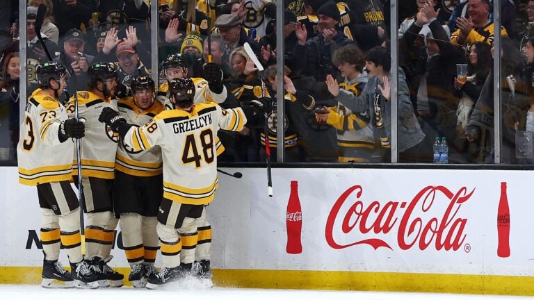 BOSTON, MASSACHUSETTS - JANUARY 20: Charlie Coyle #13 of the Boston Bruins celebrates with Matt Grzelcyk #48, Charlie McAvoy #73, Brad Marchand #63 and David Pastrnak #88 after scoring against the Montreal Canadiens during the second period at TD Garden on January 20, 2024 in Boston, Massachusetts.