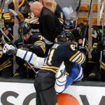 Boston Bruins left wing Pat Maroon (61) checks Toronto Maple Leafs defenseman Timothy Liljegren (37) into the Bruins bench during first period NHL action at TD Garden.