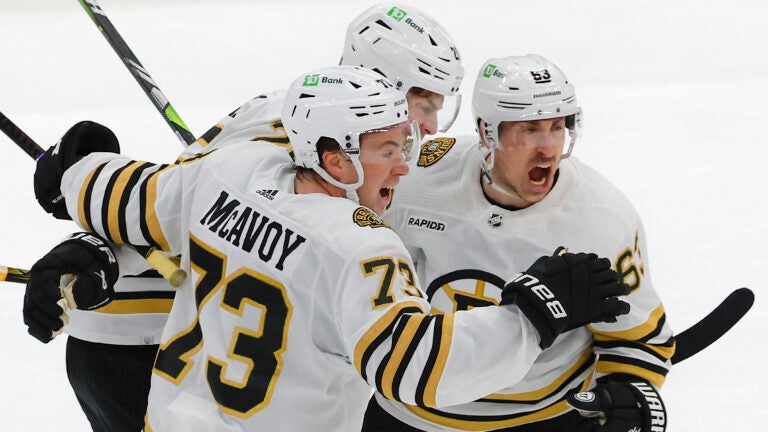 Boston Bruins left wing Brad Marchand (63) celebrates his goal with teammates Charlie McAvoy (73) and Brandon Carlo (25) against the Toronto Maple Leafs during third period action of the NHL Playoffs in game 3, of round 1, at Scotiabank Arena.