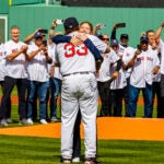 Brianna Wakefield, daughter of the late Tim and Stacy Wakefield, hugs former Red Sox catcher Jason Varitek after she threw out the first pitch at the Red Sox' home opener.