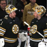 Bruins goaltender Jeremy Swayman (1)(left) chats with Boston Bruins goaltender Linus Ullmark (35) during pregame warmups.