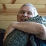 Joie Henney hugs his emotional support alligator.