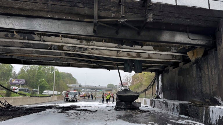 Emergency personnel work at the scene of a fiery early morning crash that left both sides of Interstate 95.