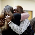 Eric Posey, of Post Falls, Idaho, embraces a supporter in court.