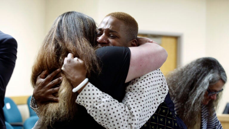 Eric Posey, of Post Falls, Idaho, embraces a supporter in court.
