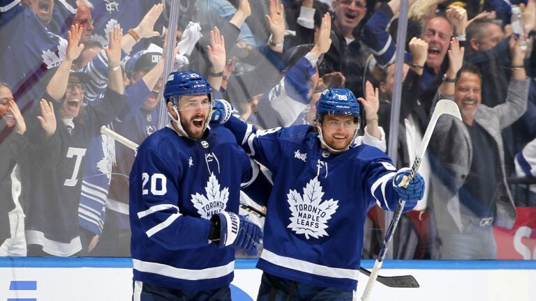 Joel Edmundson #20 and William Nylander #88 of the Toronto Maple Leafs celebrate after Nylander's goal against the Bruins during the third period.