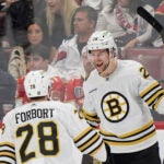 Boston Bruins defenseman Brandon Carlo (25) celebrates his goal with defenseman Derek Forbort (28) during the second period of Game 1 of the second-round series of the Stanley Cup Playoffs against the Florida Panthers, Monday, May 6, 2024, in Sunrise, Fla.