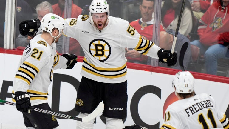 Bruins right wing Justin Brazeau celebrates his goal with left wing James van Riemsdyk and center Trent Frederic during the third period of Game 1 against the Florida Panthers.