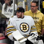 Boston Bruins goaltender Jeremy Swayman watches from the bench during the third period of Game 2 against the Florida Panthers of a second-round series of the NHL hockey Stanley Cup playoffs Wednesday, May 8, 2024, in Sunrise, Fla.