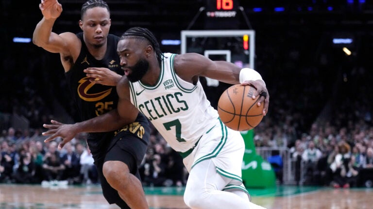 Celtics guard Jaylen Brown drives to the basket against Cleveland Cavaliers forward Isaac Okoro during the second half of Game 1 in Boston.