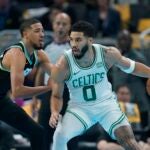 Boston Celtics' Jayson Tatum, right, is defended by Indiana Pacers' Tyrese Haliburton, left, during the first half half of an NBA basketball In-Season Tournament game, Monday, Dec. 4, 2023, in Indianapolis.