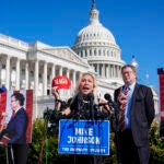 Rep. Marjorie Taylor Greene, R-Ga., joined by Rep. Thomas Massie, R-Ky., says she'll call a vote next week on ousting House Speaker Mike Johnson, R-La., during a news conference at the Capitol in Washington, Wednesday, May 1,