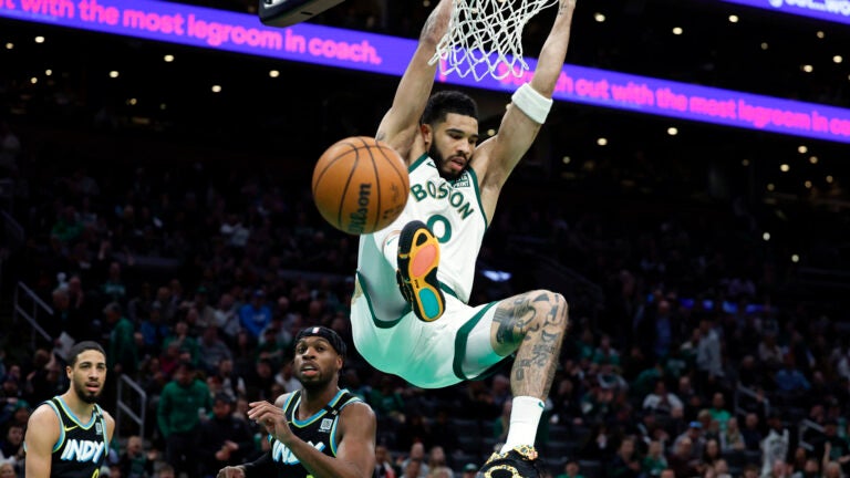 Boston Celtics forward Jayson Tatum (0) dunks over the Indiana Pacers in the first quarter at TD Garden.