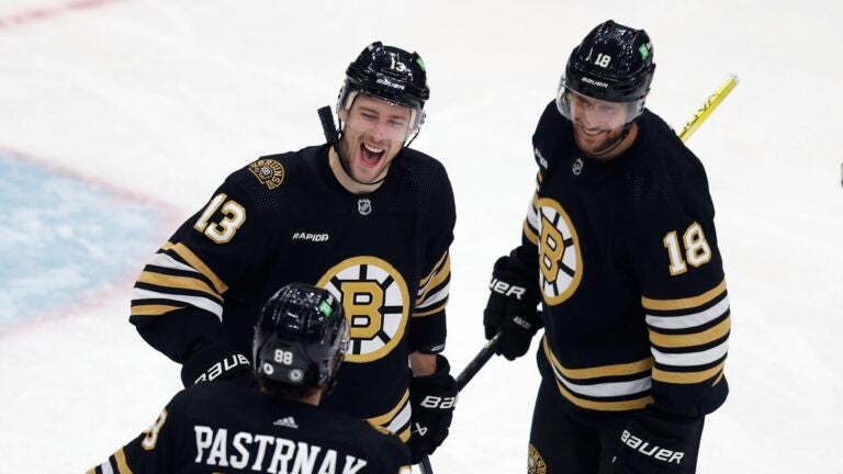 Boston Bruins' Charlie Coyle (13) celebrates after his goal with Pavel Zacha (18) and David Pastrnak (88) during the second period of an NHL hockey game against the Anaheim Ducks, Thursday, Oct. 26, 2023, in Boston.