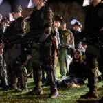 Dartmouth College student Maya Beauvineau, sings as police remove pro-Palestinian protesters from the campus.