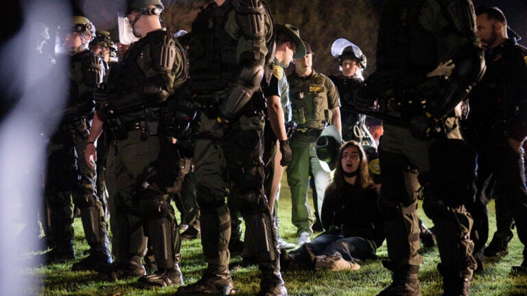 Dartmouth College student Maya Beauvineau, sings as police remove pro-Palestinian protesters from the campus.
