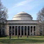 Students walk past the "Great Dome" atop Building 10 on the Massachusetts Institute of Technology campus.