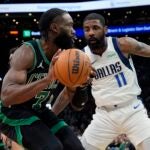 Boston Celtics' Jaylen Brown (7) looks to move against Dallas Mavericks' Kyrie Irving (11) during the first half of an NBA basketball game, Friday, March 1, 2024, in Boston.