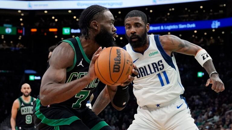 Boston Celtics' Jaylen Brown (7) looks to move against Dallas Mavericks' Kyrie Irving (11) during the first half of an NBA basketball game, Friday, March 1, 2024, in Boston.
